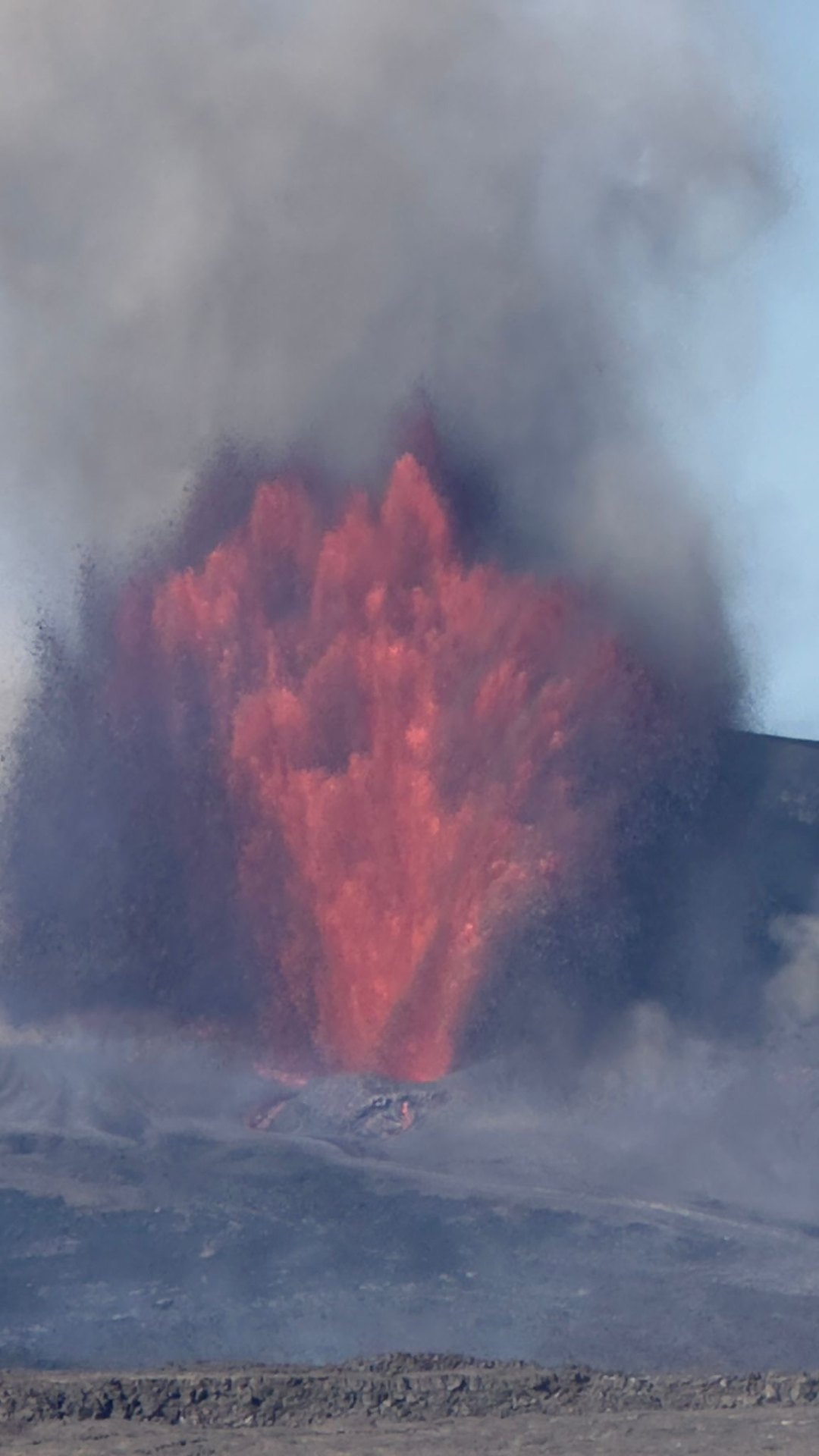 Tall red lava fountain jetting into the sky
